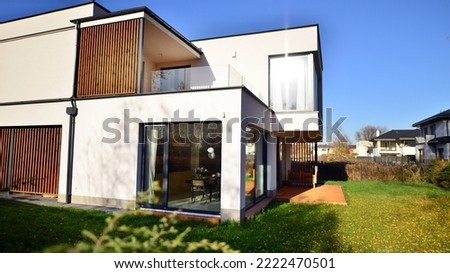 Cubist architecture. Cozy and modern house with garage and cobblestone driveway. Modern architecture. Royalty-Free Stock Photo #2222470501