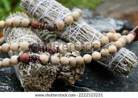 White sage smudge sticks with wooden prayer beads. 