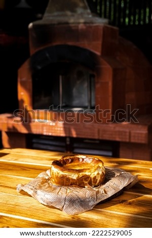 An image of the atmosphere of making a cheesecake in the provinces baking from the wood fired oven, a picture of the morning  with soft sunlight along with the finished dessert and a cup of coffee