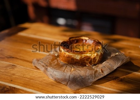 An image of the atmosphere of making a cheesecake in the provinces baking from the wood fired oven, a picture of the morning  with soft sunlight along with the finished dessert and a cup of coffee
