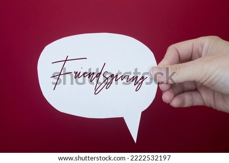 Speech bubble in front of colored background with Friendsgiving text.