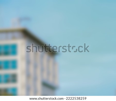 Blured photo of a city building or multi-storey apartment with a blue sky