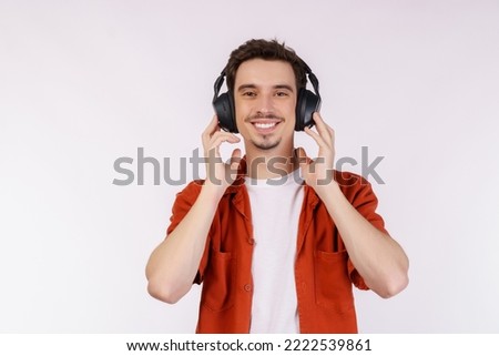 Portrait of happy young man wearing headphone and enjoy music over white background. Relax, favorite music, fun and pleasure at spare time concept.