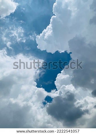 Hot day and clear skies causing white cumulus clouds to float in the sky at Bangkok, Thailand.no focus Royalty-Free Stock Photo #2222541057