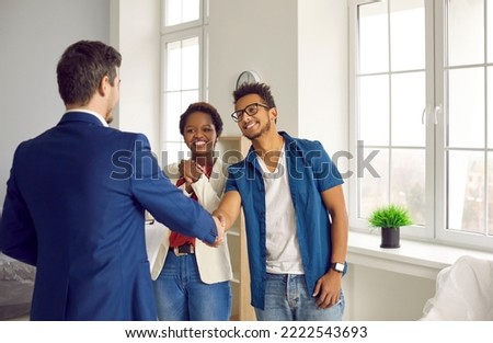 Male realtor or broker shake hand greet excited couple buyers with house buying. Real estate agent handshake clients congratulate with home ownership. Property purchase. Rent, realty concept. Royalty-Free Stock Photo #2222543693