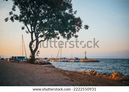 Picturesque sea Adriatic coast of Croatia. View on cape Jadran. Turquoise Mediteran sea and rocky shore with evergreen coniferous trees. Beautiful clouds in blue sky. Wonderful summer landscape Royalty-Free Stock Photo #2222550931