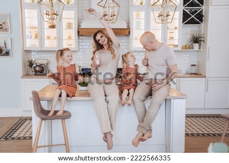 Swedish family sitting on the table at kitchen on Sunday morning, having breakfast together. Family at home having fun. Domestic leisure and health care concept. Royalty-Free Stock Photo #2222566335