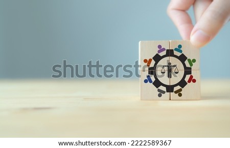 Business ethics concept. Ethical corporate culture. Ethical investment, sustianable development. Business integrity and moral. Putting wooden cubes with ethics mindset and teamwork icons. Royalty-Free Stock Photo #2222589367