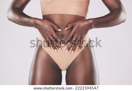 Healthy black woman, heart hands and stomach diet, weightloss wellness and gut health, body contouring and slimming on studio background. Fitness model abdomen, love and digestion, skincare and belly Royalty-Free Stock Photo #2222594547