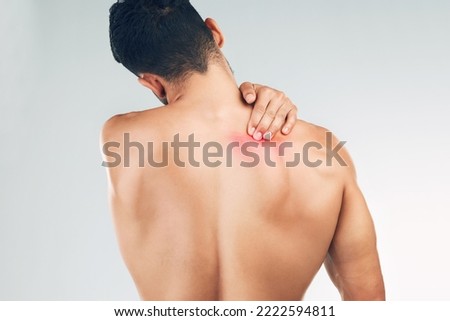 Back pain, injury and man with medical problem, tension and stress against grey mockup studio background. Back of a person with a body symptom, inflammation and muscle pain with mock up space Royalty-Free Stock Photo #2222594811