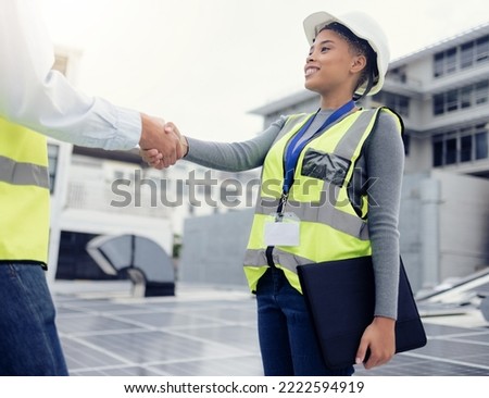 Engineering team handshake, black woman at solar panel construction site or architecture project partnership. Working on building roof, industrial collaboration or contractor welcome employee