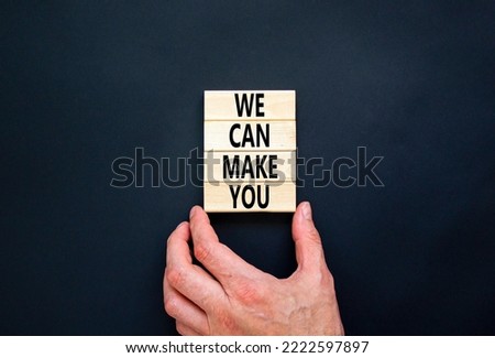 Support and we can make you symbol. Concept words We can make you on wooden blocks. Beautiful black table black background. Businessman hand. Business psychological we can make you concept. Copy space