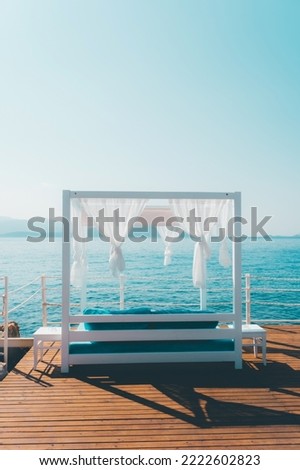 White beach canopies. Luxury beach cabana at a resort. View of pier beach scenery, vacation and travel background concept.