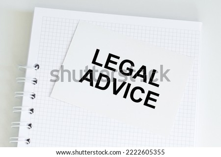Legal Advice text on card on a blank blaknot page on the table