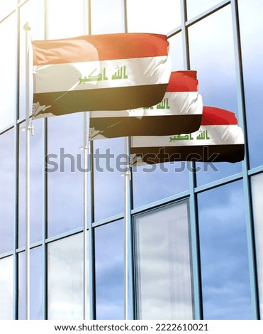 Flagpoles with the flag of Iraq in front of the business center