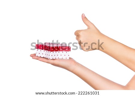 Little red box star on the palm of girl, isolated on a white background, closeup