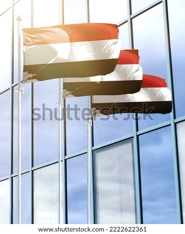 Flagpoles with the flag of Yemen in front of the business center