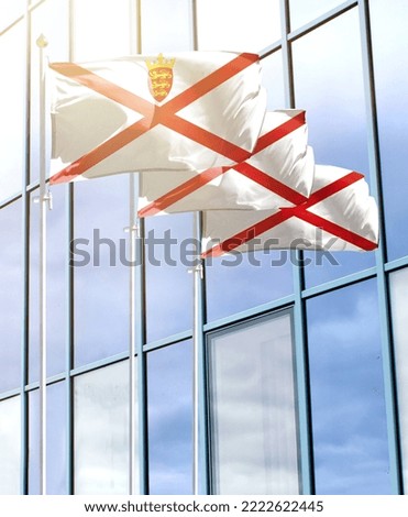 Flagpoles with the flag of Jersey in front of the business center