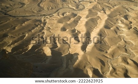 Gorgeous aerial drone top bird's eye view of incredible golden  desert mountains of tzin river. desert in Israel