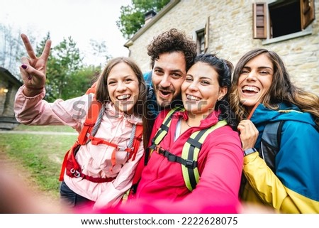 Happy friends group taking selfie at trekking excursion by countryside cottage - Sporty life style concept with young millenial people having fun together at camping experience - Bright vivid filter