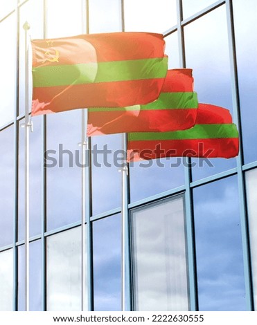 Flagpoles with the flag of Transnistria in front of the business center