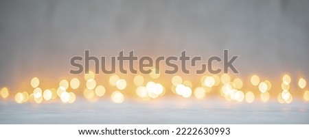 Yellow golden bokeh lights on white or light gray texture background for Christmas and winter holidays