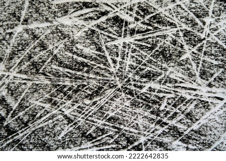 Sharp slashing white lines scratched or etched or scribbled 
on a black crayon paper background. Dramatic dynamic abstract texture and pattern. Royalty-Free Stock Photo #2222642835