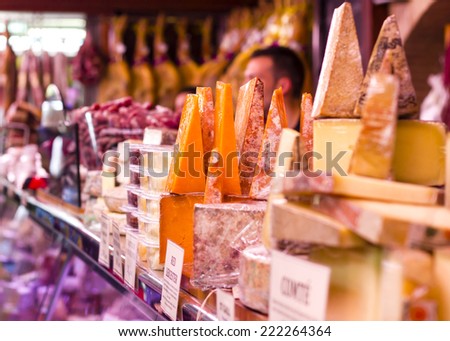Various types of hard cheeses at Valencia Mercado de Colon historic Market in Valencia, Spain