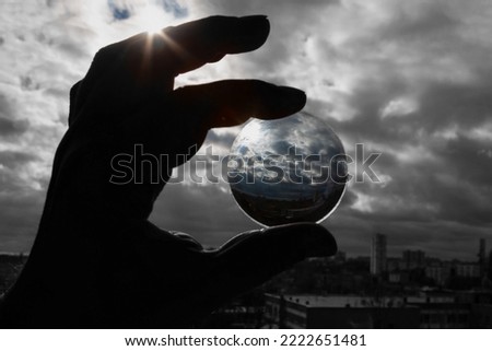 View of the landscape through a magnifying glass in sunlight. Converting an image from black and white to color