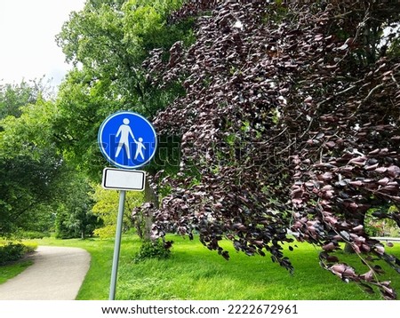 Road sign Footpath in park on sunny day