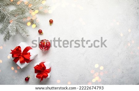 Merry Christmas and Happy Holidays greeting card, frame, banner. New Year. Noel. Christmas white handmade gifts and red decor on light background top view. Winter xmas holiday theme. Flat lay Royalty-Free Stock Photo #2222674793