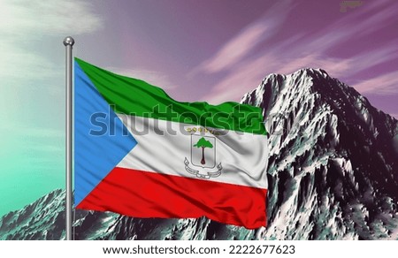 Equatorial Guinea national flag cloth fabric waving on beautiful mountain background.