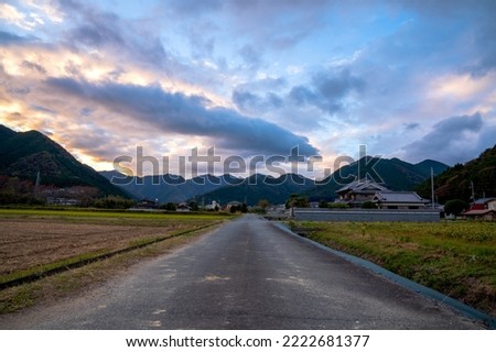 Scenery with mountains, rivers, sky, and rice fields in a small town in Japan.