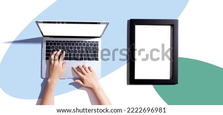 Laptop computer with a blank photo frame - flat lay