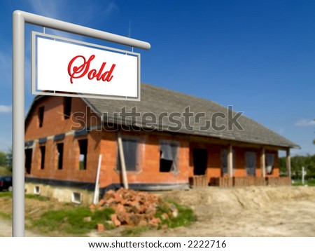 Sold sign in front of house in progress, under construction.  Real estate concept.