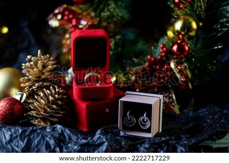 Gold ring in a red box for Christmas gift, Christmas decorations 