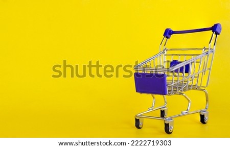 shopping trolley supermarket trolley isolated on yellow background