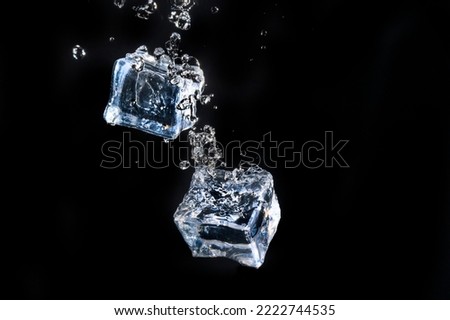 ice cube in water jet on black background