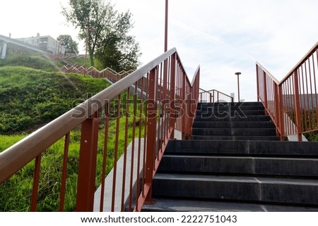 Photo of a staircase and a red railing