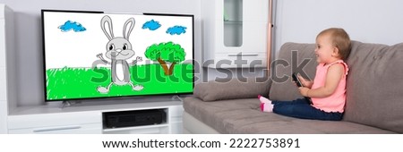 Baby Watching TV Cartoon. Small Child Watching Television