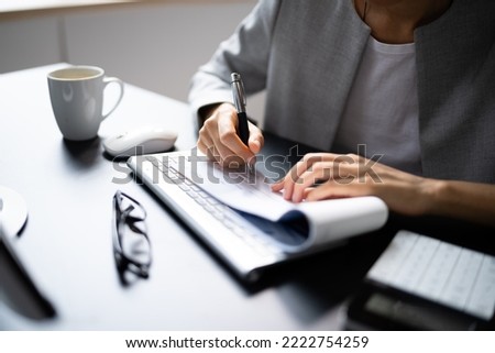 African Woman Signing Bank Check Or Paycheck