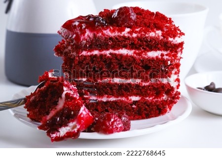 Part of a raspberry dessert cake on a plate in bright light. Shallow depth of field