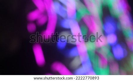 Blurred picture of a colorful Ferris wheel in the night market