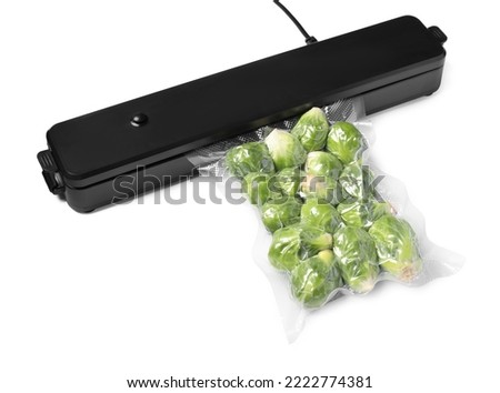 Sealer for vacuum packing and plastic bag with Brussels sprouts on white background Royalty-Free Stock Photo #2222774381