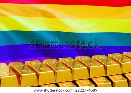 Row of shining golden bullions on the LGBT flag background. Concept of gold reserve and gold fund of LGBT