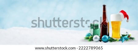 Christmas festive background with bottle and glass of beer, gifts, colored balls and Christmas tree's branches. Christmas background concept