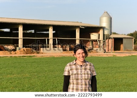 portrait of a farmer outside behind a farm