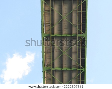 The underside of a green suspension bridge that spans from Ontario, Canada to New York, United States of America. Royalty-Free Stock Photo #2222807869