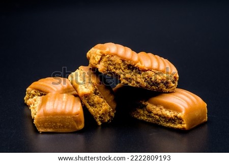 toffee chocolate candies set, close up view on a black background, studio photo Royalty-Free Stock Photo #2222809193