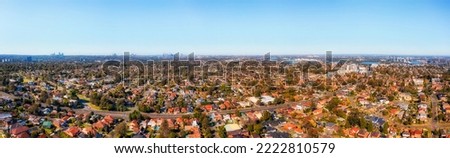 Wide aerial panorama of Western Sydney from City of Ryde to distant CBD high-rise towers on horizon skyline. Royalty-Free Stock Photo #2222810579